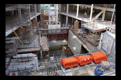The basement has been constructed using top-down construction, enabling the superstructure to be built at the same time, which has saved six months on the programme. The earth is scooped out of these cut-outs in the ground floor slab